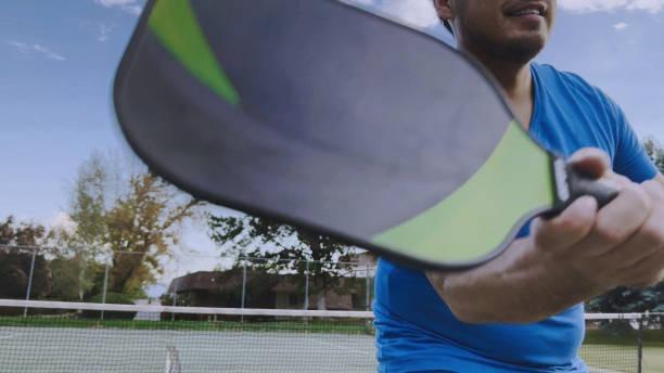Close-up action shot of a beginner-friendly pickleball paddle striking the ball, highlighting the large sweet spot designed for consistent play.