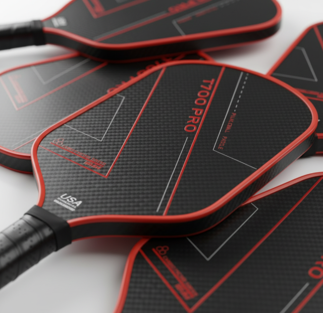 Close-up showing the textured raw surface of multiple T700 carbon fiber pickleball paddles aimed at generating spin