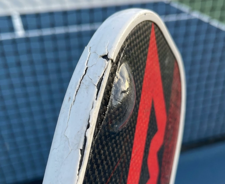 Cracked and damaged edge of pickleball paddle. Obvious sign when to replace pickleball paddle.